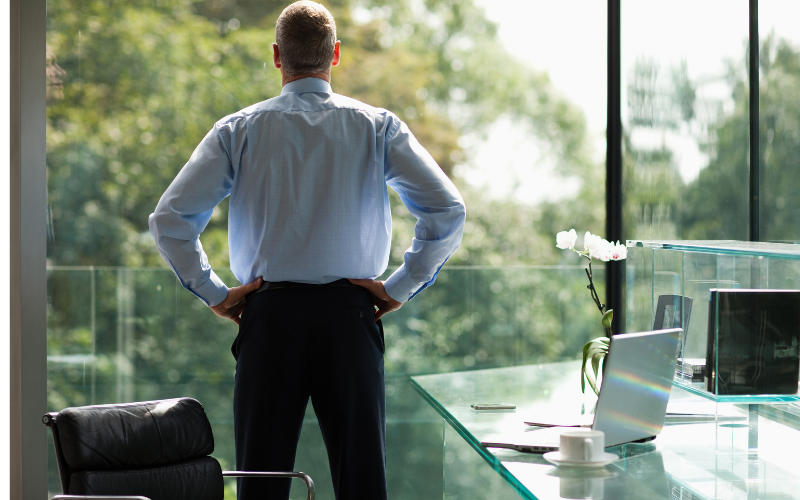 Businessman deep in thought while looking out office window